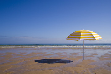 Image showing yellow umbrella at the beach