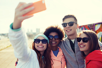 Image showing smiling friends taking selfie with smartphone