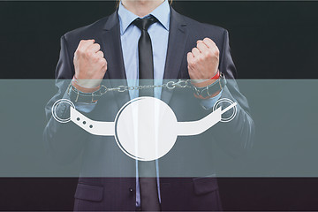 Image showing man in a business suit with chained hands. handcuffs for sex games. concept of erotic entertainment.