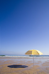 Image showing yellow umbrella at the beach