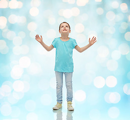 Image showing happy little girl looking up to something