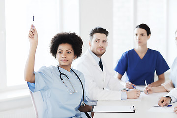 Image showing group of happy doctors on conference at hospital