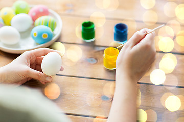 Image showing close up of woman coloring easter eggs