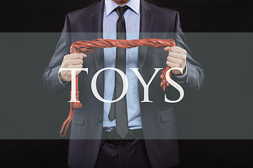 Image showing man in business suit with chained hands. handcuffs for sex games. concept of erotic entertainment.