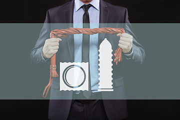 Image showing man in business suit with chained hands. handcuffs for sex games. concept of erotic entertainment.