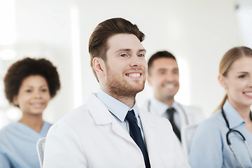 Image showing happy doctor over group of medics at hospital