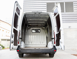 Image showing empty minivan car with open doors on city parking