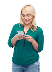 Image showing happy woman with smartphone texting message