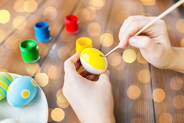 Image showing close up of woman hands coloring easter eggs