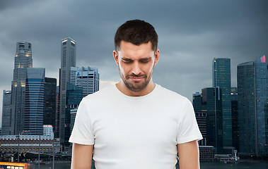 Image showing unhappy man over evening singapore city background