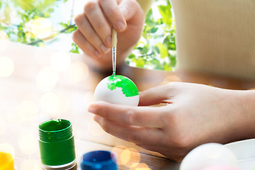 Image showing close up of woman hands coloring easter eggs