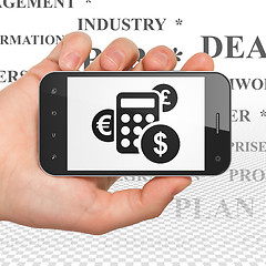 Image showing Finance concept: Hand Holding Smartphone with Calculator on display