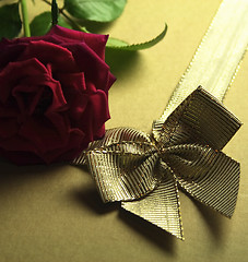 Image showing red rose and golden ribbon