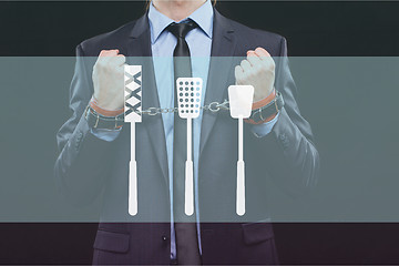 Image showing man in a business suit with chained hands. handcuffs for sex games. concept of erotic entertainment.