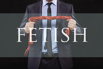 Image showing man in business suit with chained hands. handcuffs for sex games. concept of erotic entertainment.