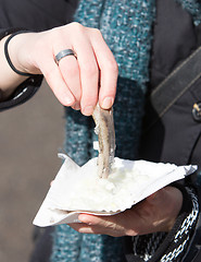 Image showing Dutch woman is eating typical raw herring