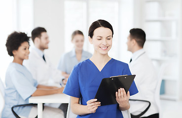 Image showing happy doctor over group of medics at hospital