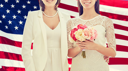 Image showing close up of happy lesbian couple with flowers