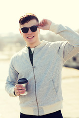 Image showing smiling young man or boy drinking coffee