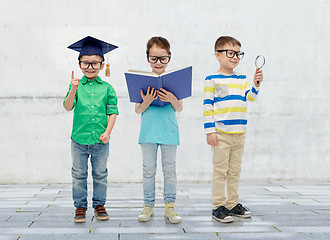 Image showing kids in glasses with book, lens and bachelor hat