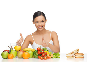 Image showing woman with fruits showing thumbs up