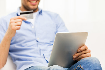 Image showing close up of man with tablet pc and credit card