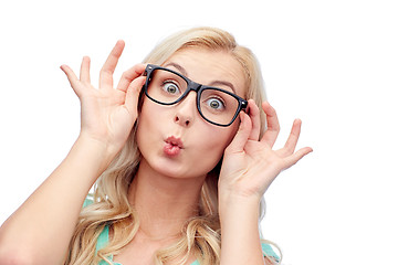 Image showing happy young woman in glasses making fish face