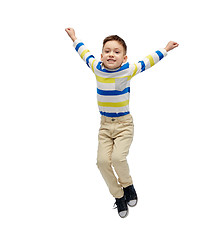 Image showing happy little boy jumping in air