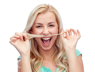 Image showing happy young woman making mustache with her hair