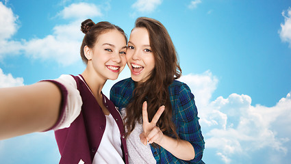 Image showing happy friends taking selfie and showing peace