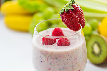 Image showing close up of glass with milk shake and fruits