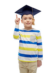 Image showing happy boy in bachelor hat pointing finger up