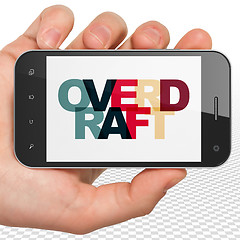 Image showing Finance concept: Hand Holding Smartphone with Overdraft on  display