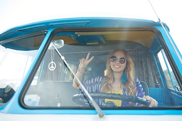Image showing smiling young hippie woman driving minivan car
