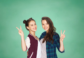 Image showing happy teenage student girls showing peace sign