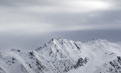 Image showing High snowy mountains and gray sky before blizzard