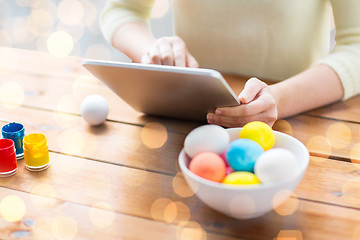 Image showing close up of woman with tablet pc and easter eggs