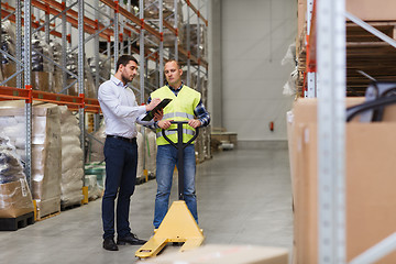 Image showing worker and businessmen with clipboard at warehouse