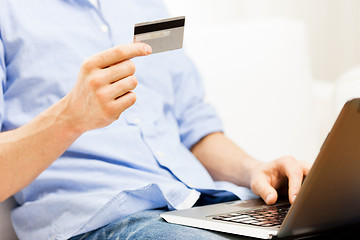 Image showing close up of man with laptop and credit card