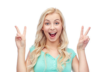 Image showing smiling young woman or teenage girl showing peace