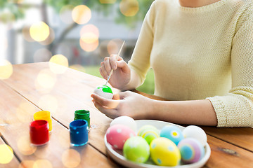 Image showing close up of woman hands coloring easter eggs