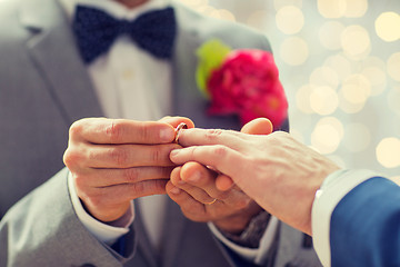 Image showing close up of male gay couple hands and wedding ring