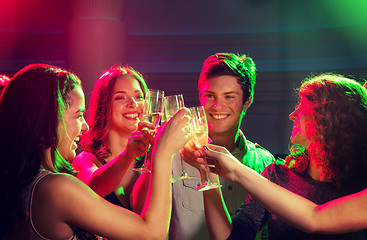 Image showing smiling friends with glasses of champagne in club