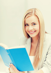 Image showing young woman reading book