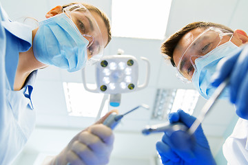 Image showing close up of dentist and assistant at dental clinic