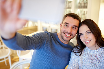 Image showing couple taking smartphone selfie at cafe restaurant