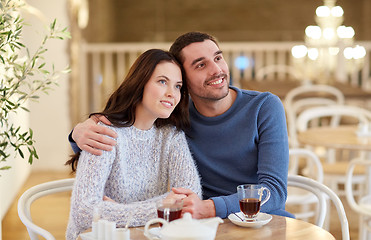 Image showing happy couple drinking tea at restaurant