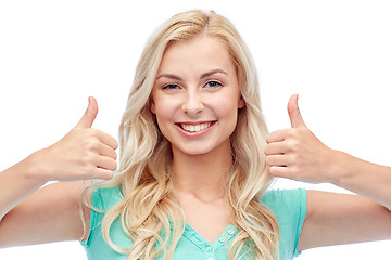 Image showing happy woman or teenage girl showing thumbs up