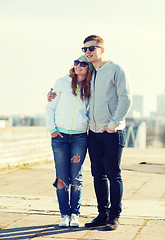 Image showing happy teenage couple walking in city