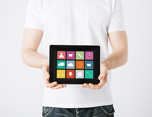 Image showing close up of man with app icons on tablet pc